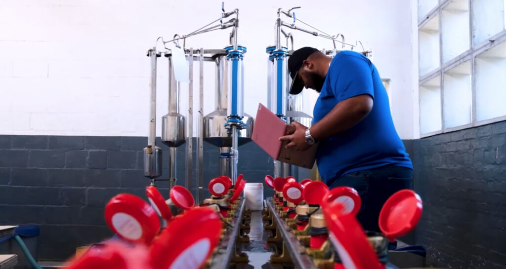 Water meters being inspected and signed off by water meter inspector at manufacturing plant